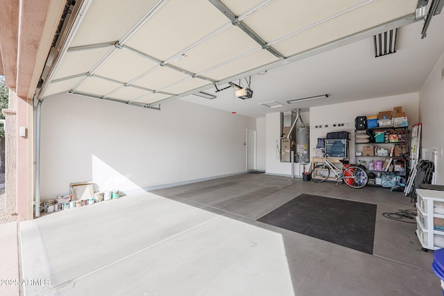 garage featuring a garage door opener and gas water heater