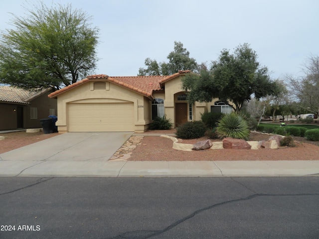 mediterranean / spanish-style home with a garage