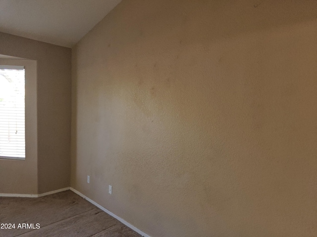 spare room with lofted ceiling