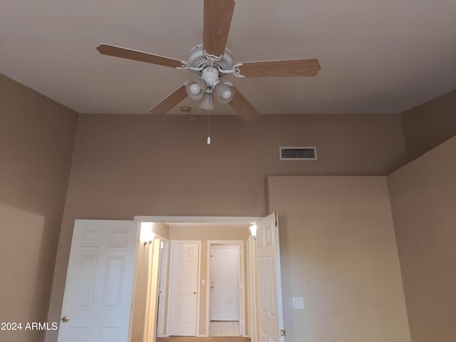 unfurnished bedroom with tile patterned floors and ceiling fan