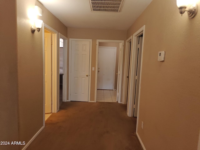 hall with light colored carpet