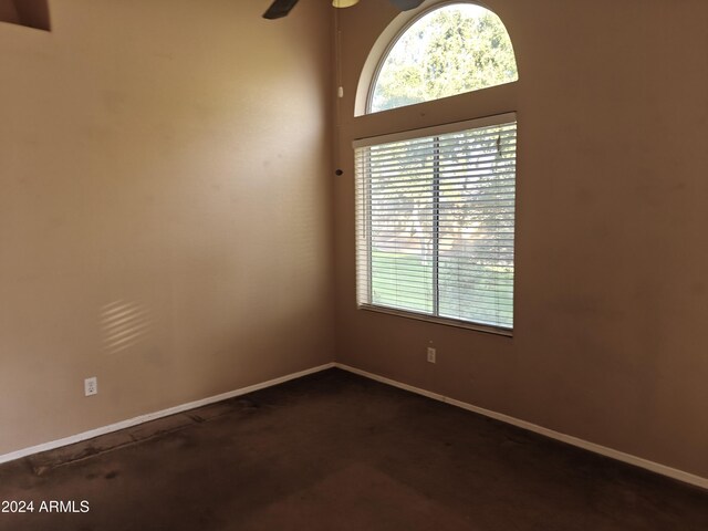 spare room with a high ceiling and ceiling fan