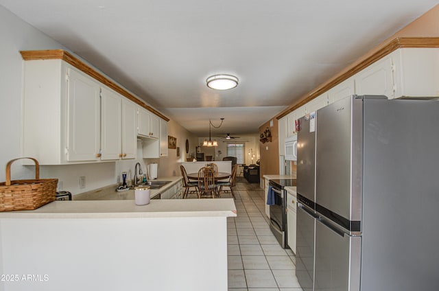 kitchen featuring light tile patterned flooring, appliances with stainless steel finishes, sink, white cabinets, and kitchen peninsula