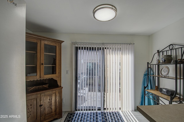 doorway with light tile patterned floors