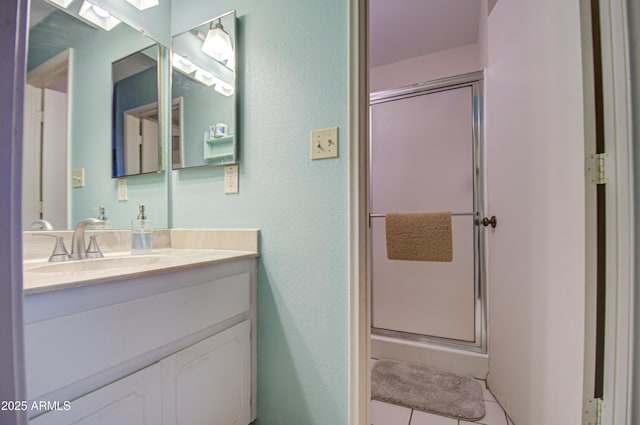 bathroom with vanity, tile patterned floors, and a shower with shower door