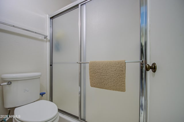 bathroom with an enclosed shower and toilet