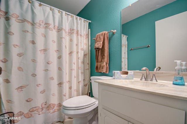 bathroom featuring vanity, curtained shower, and toilet