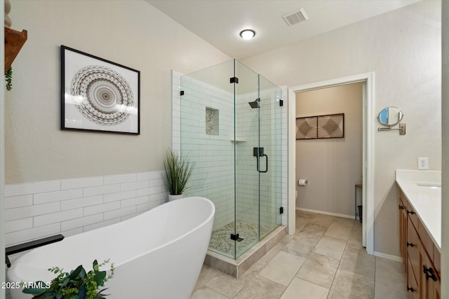 19700 N 76th St Unit 2086, Scottsdale, AZ 85255 - full bathroom featuring a stall shower, a freestanding tub, toilet, vanity, and visible vents