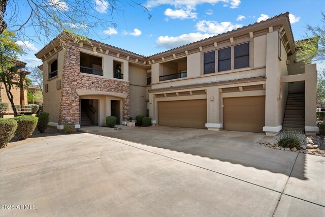 19700 N 76th St Unit 2086, Scottsdale, AZ 85255 - view of front of property featuring stone siding, stucco siding, a garage, and stairway