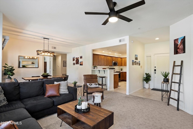 19700 N 76th St Unit 2086, Scottsdale, AZ 85255 - living area featuring light colored carpet, recessed lighting, ceiling fan with notable chandelier, baseboards, and visible vents