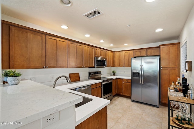 19700 N 76th St Unit 2086, Scottsdale, AZ 85255 - kitchen with visible vents, brown cabinets, stainless steel appliances, and recessed lighting