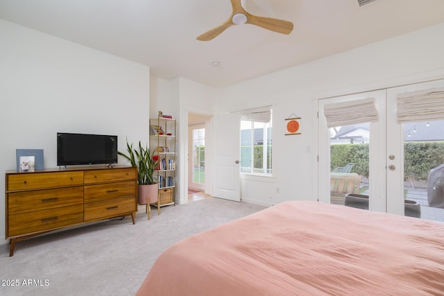 bedroom with light carpet, access to outside, french doors, and ceiling fan