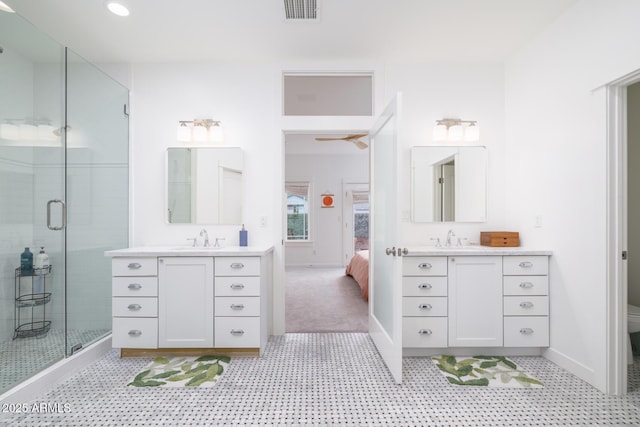 bathroom featuring vanity, toilet, and an enclosed shower