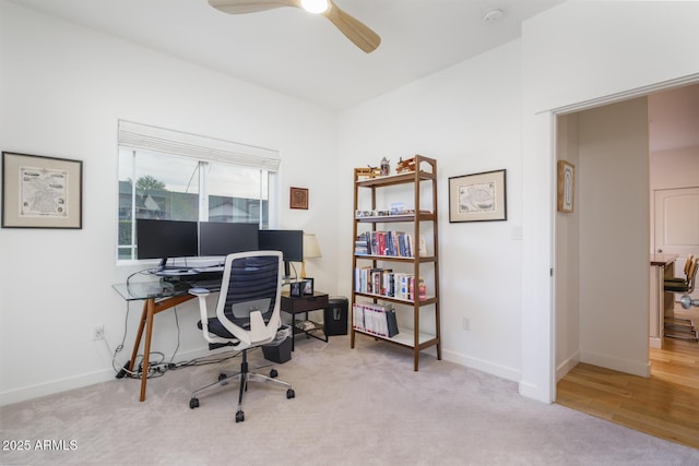 carpeted home office with ceiling fan