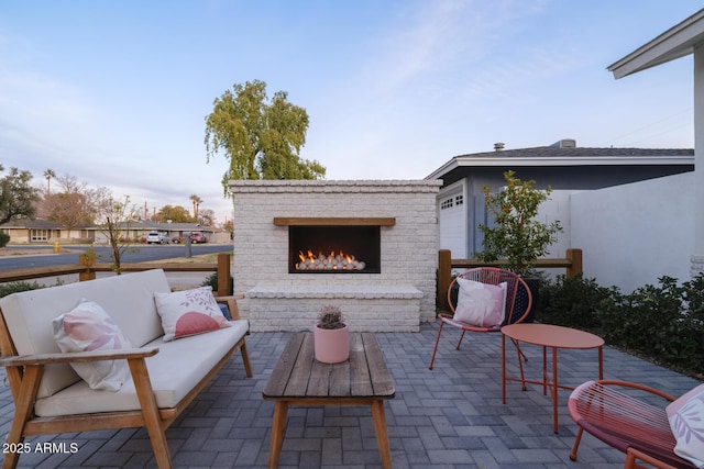 view of patio / terrace featuring an outdoor brick fireplace