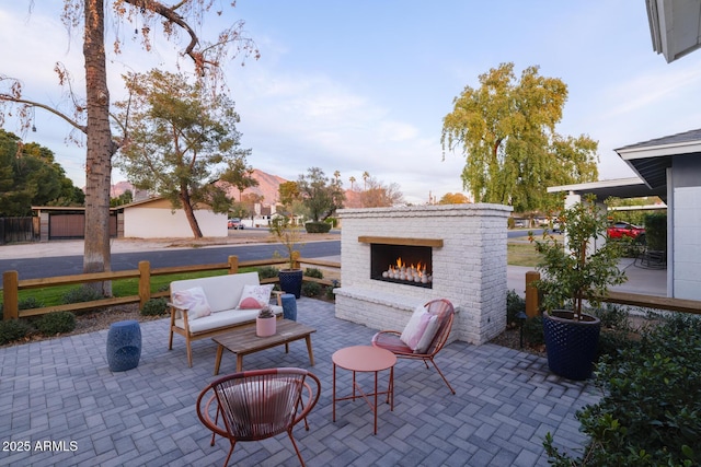 view of patio featuring an outdoor living space with a fireplace