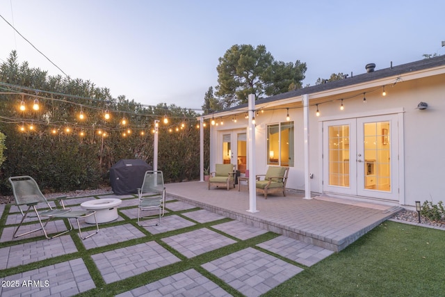 patio terrace at dusk with grilling area and french doors