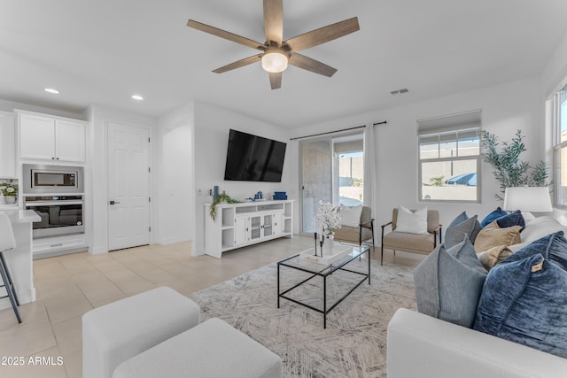 living room featuring ceiling fan and light tile patterned floors