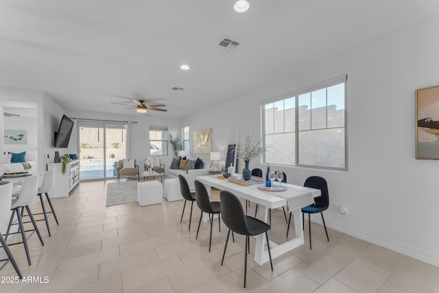 tiled dining space featuring ceiling fan