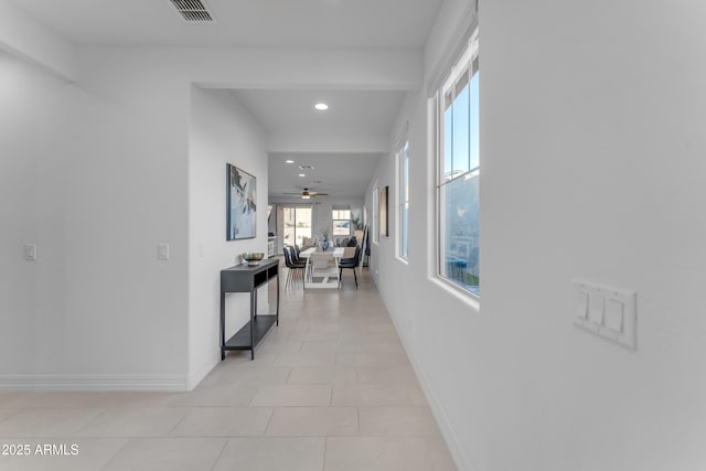 hall featuring light tile patterned floors