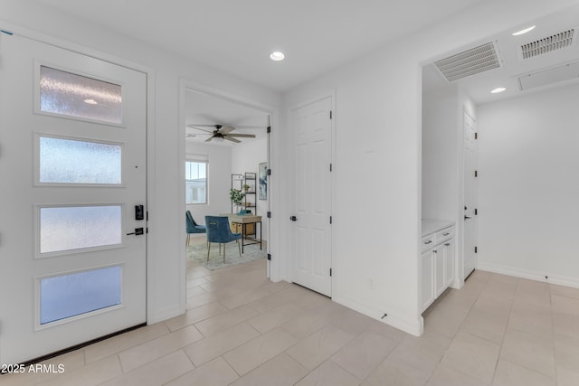 tiled foyer entrance featuring ceiling fan