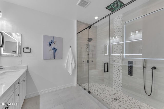 bathroom featuring tile patterned floors, vanity, and a shower with shower door