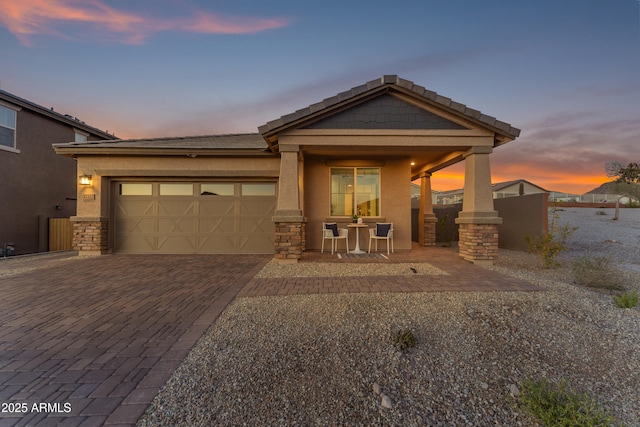 view of front of property featuring a garage and covered porch