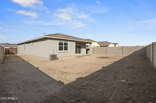 rear view of house featuring central AC unit