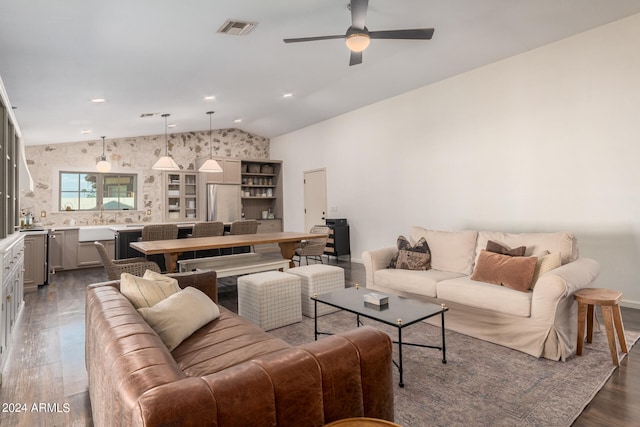 living room featuring lofted ceiling, ceiling fan, and dark hardwood / wood-style flooring