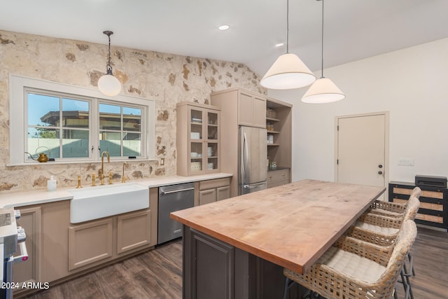 kitchen featuring a center island, gray cabinetry, sink, hanging light fixtures, and appliances with stainless steel finishes