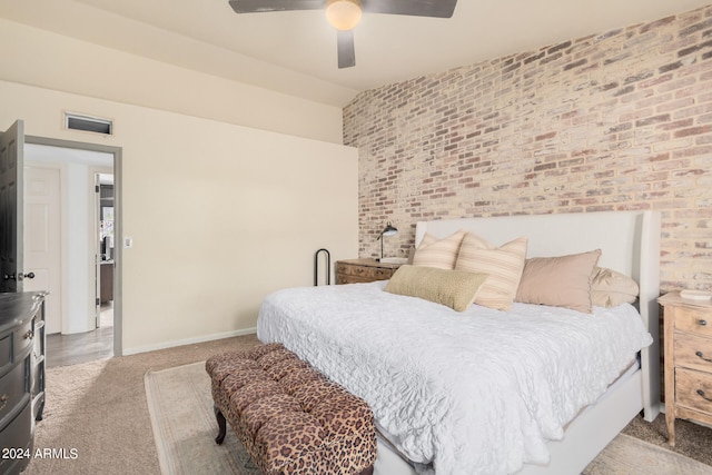 bedroom featuring light colored carpet, brick wall, and ceiling fan