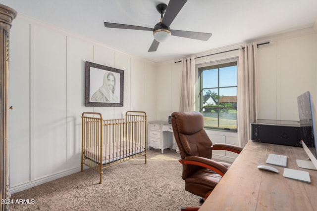 bedroom featuring ceiling fan, a nursery area, and carpet