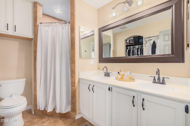 bathroom featuring vanity, toilet, and curtained shower