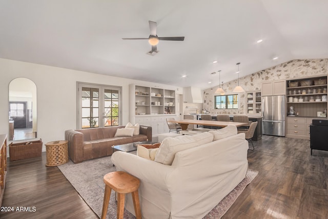 living room featuring ceiling fan, dark hardwood / wood-style floors, and vaulted ceiling