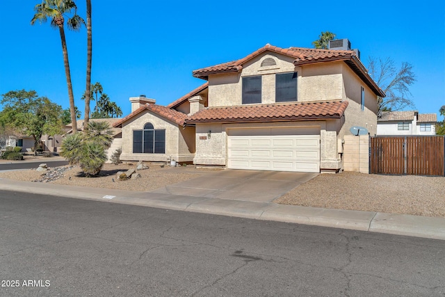 mediterranean / spanish-style house with a tile roof, a chimney, concrete driveway, and stucco siding