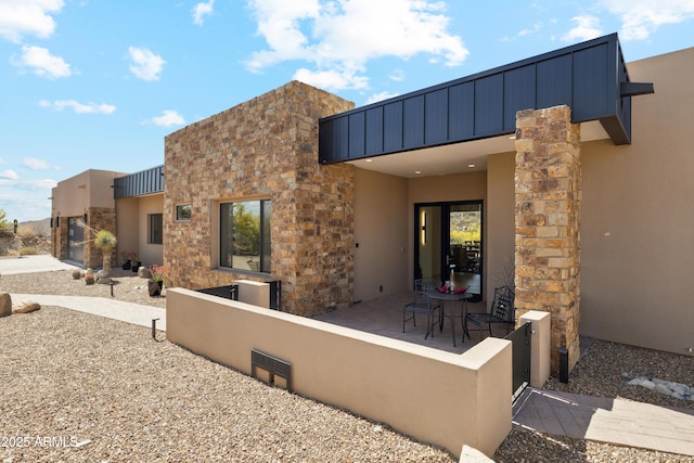 back of house featuring fence private yard and stucco siding