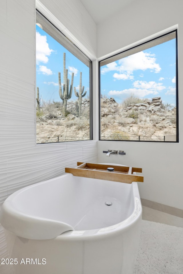 full bath featuring a freestanding bath