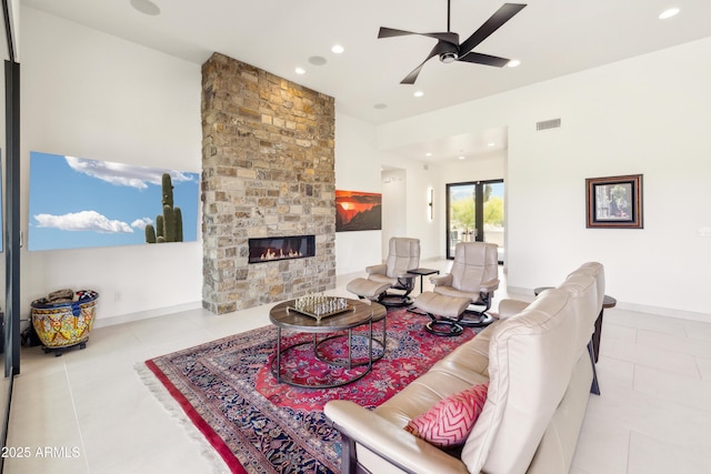 living room featuring visible vents, a stone fireplace, recessed lighting, tile patterned floors, and a ceiling fan