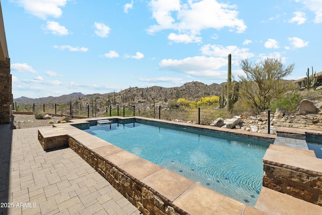 outdoor pool with fence and a mountain view
