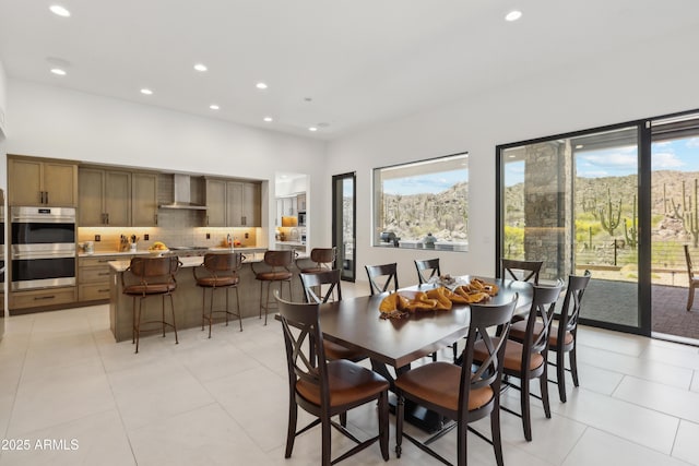 dining space featuring recessed lighting and light tile patterned floors