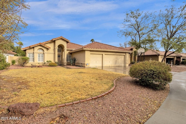 mediterranean / spanish-style house featuring concrete driveway, a tiled roof, an attached garage, and stucco siding