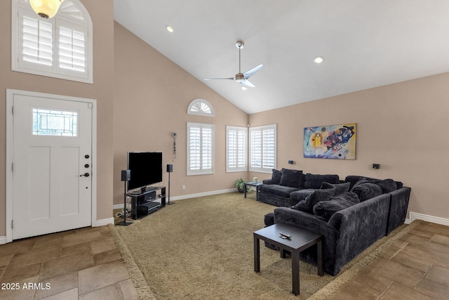 living area with carpet floors, baseboards, high vaulted ceiling, and a ceiling fan