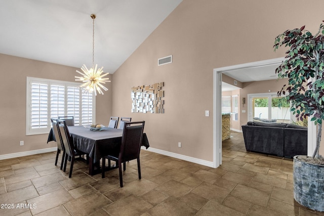 dining area with high vaulted ceiling, visible vents, baseboards, and an inviting chandelier