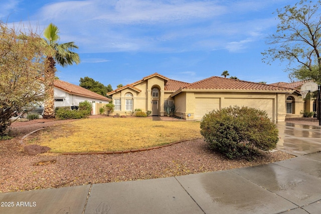 mediterranean / spanish-style home featuring a front yard, a tiled roof, an attached garage, and stucco siding