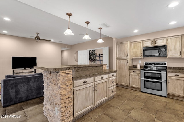 kitchen with black microwave, range with two ovens, visible vents, light brown cabinetry, and dark countertops