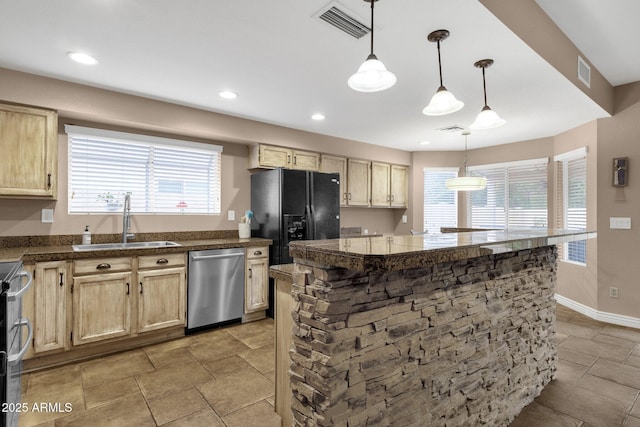 kitchen with a wealth of natural light, visible vents, appliances with stainless steel finishes, and a sink