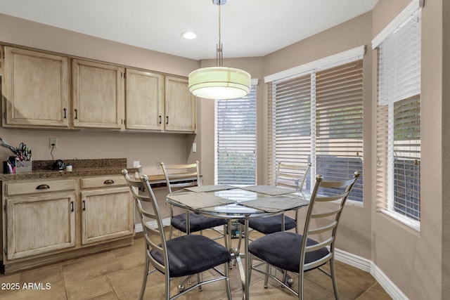 dining space featuring baseboards