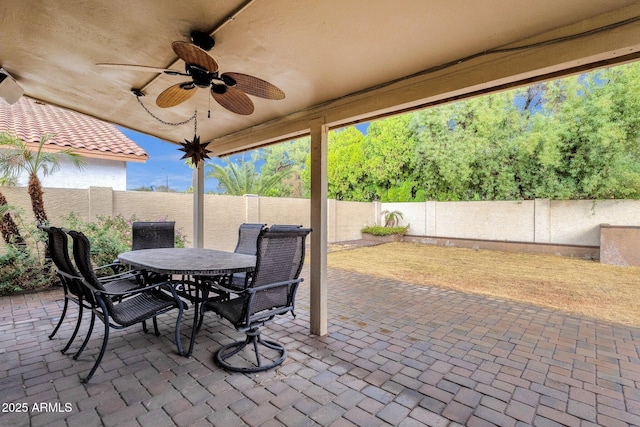 view of patio / terrace featuring ceiling fan, outdoor dining space, and a fenced backyard