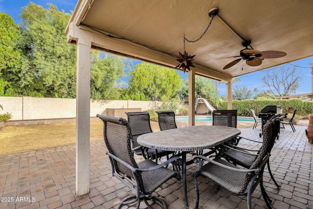 view of patio featuring a fenced in pool, a fenced backyard, and ceiling fan