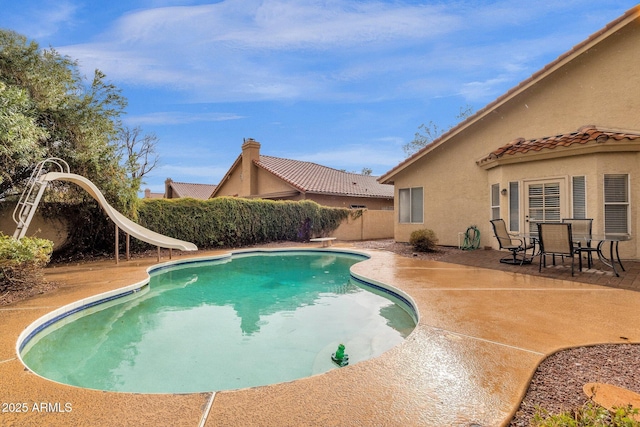 view of pool with a patio, a water slide, a fenced backyard, a diving board, and a fenced in pool